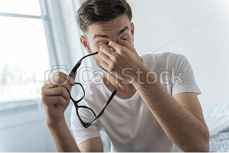 sad-tired-man-holding-his-glasses-stock-photos_csp49618836.jpg